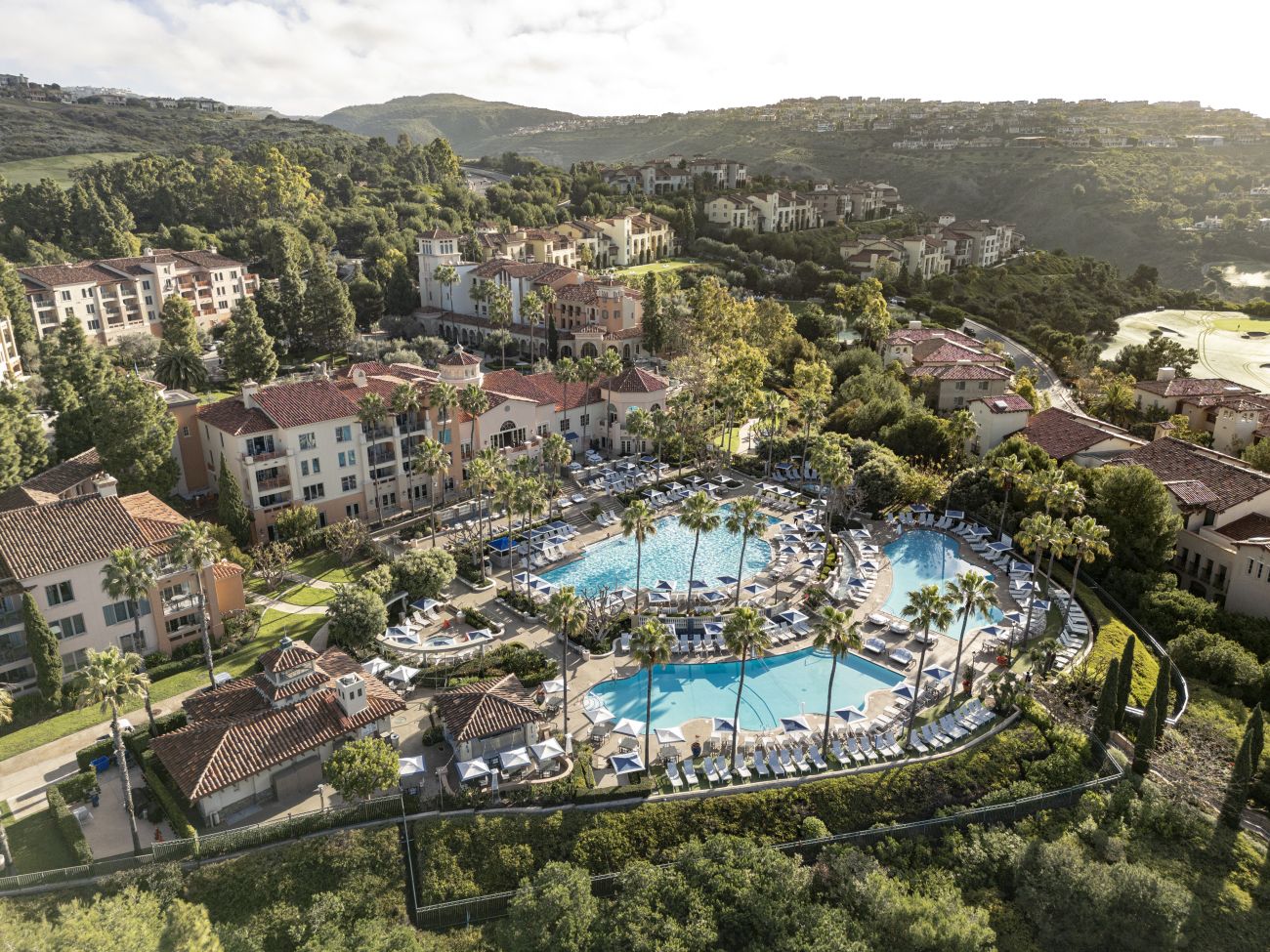 Exterior of Marriott's Newport Coast Villas resort timeshare with sun setting over water